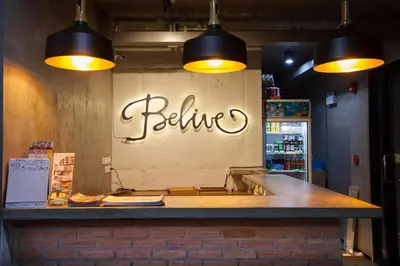 a bar with two lights hanging over a counter at Be Live Residence in Thalang