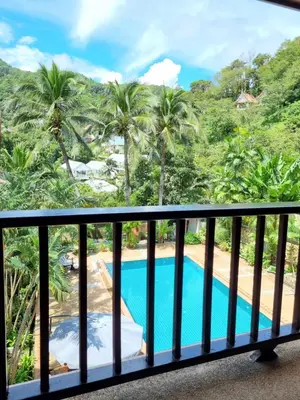 a view from the balcony of a resort with a swimming pool at Kata Interhouse Resort by Haii Collection in Kata Beach