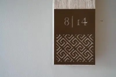 a sign on a wall with a clock on it at Baan Mai Khao in Mai Khao Beach