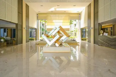 a lobby with a sculpture in the middle of a building at Baan Mai Khao in Mai Khao Beach