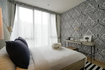 a bedroom with a bed and a window at Baan Mai Khao in Mai Khao Beach