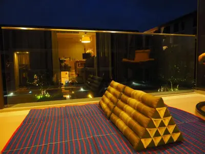 a couch sitting on a rug in a room at Baan Mai Khao in Mai Khao Beach