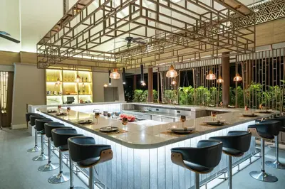 a large bar in a restaurant with stools at Dusit Thani Krabi Beach Resort in Klong Muang Beach