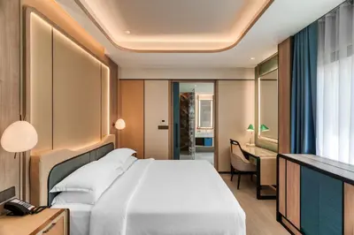 a hotel room with a bed and a desk at Dusit Thani Krabi Beach Resort in Klong Muang Beach