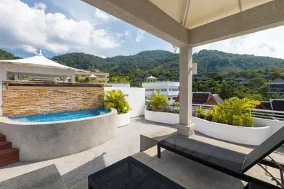 a patio with a swimming pool on top of a house at Phunawa Resort Phuket Karon Beach in Karon Beach