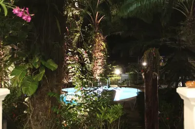 a swimming pool in a garden at night at Groovy Bungalows in Ao Nang Beach