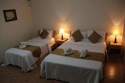 a hotel room with two beds with towels on them at Groovy Bungalows in Ao Nang Beach