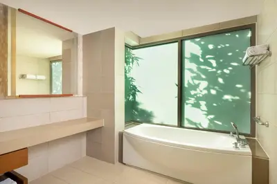a bathroom with a bath tub and a window at The Westin Siray Bay Resort & Spa, Phuket in Phuket Town