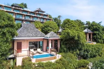 a house with a swimming pool in front of a building at The Westin Siray Bay Resort & Spa, Phuket in Phuket Town