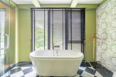 a large white tub in a bathroom with a window at See Sea Villa Phuket SHA in Patong Beach