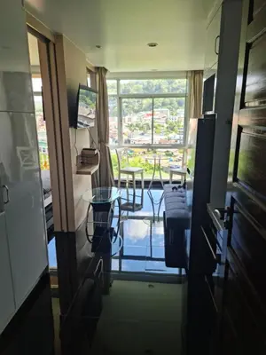 a view of a room with a table and a window at Art Patong Residence in Patong Beach