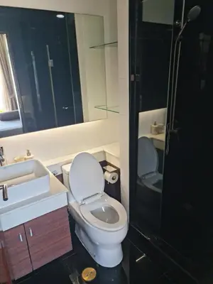 a bathroom with a toilet and a sink and a shower at Art Patong Residence in Patong Beach