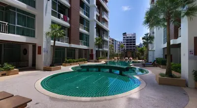 a swimming pool in the middle of a building at Art Patong Residence in Patong Beach