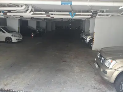 a parking garage with cars parked in it at Art Patong Residence in Patong Beach