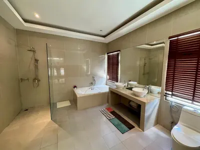 a bathroom with two sinks and a tub and a shower at Miguel Villa by G Estate in Nai Harn Beach