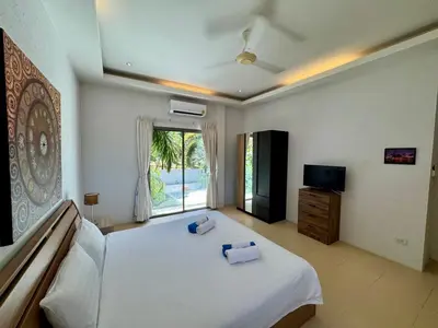 a bedroom with a bed with two towels on it at Miguel Villa by G Estate in Nai Harn Beach