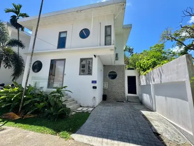 a white house with a driveway at Miguel Villa by G Estate in Nai Harn Beach