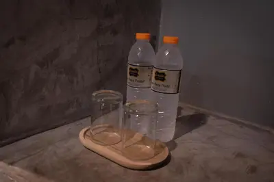 two bottles of water and a pair of slippers at Baan Paea Guest House in Ban Ket Ho