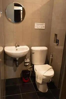 a bathroom with a toilet and a sink at Baan Paea Guest House in Ban Ket Ho