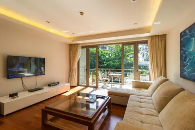 a living room with a couch and a table at Nai Thon Beachfront Apartments in Nai Thon Beach