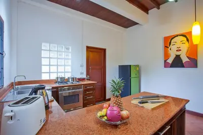 a kitchen with a bowl of fruit on a counter at Traditional Thai Villa Nikkie in Tropical Nature, 4BR & Pool, near Rawai Beach in Nai Harn Beach