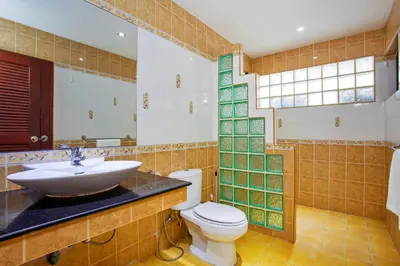 a bathroom with a sink and a toilet at Traditional Thai Villa Nikkie in Tropical Nature, 4BR & Pool, near Rawai Beach in Nai Harn Beach