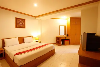 a hotel room with a bed and a television at Casa Jip Guesthouse in Patong Beach