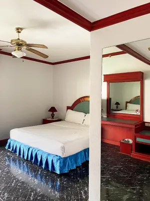 a bedroom with a bed and a mirror at Patong Palace Hotel - SHA Extra Plus in Patong Beach