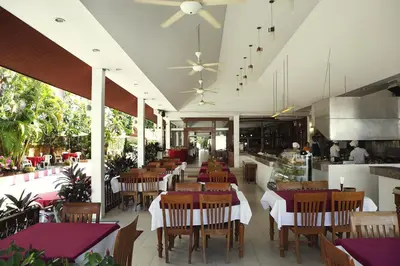 a dining room with tables and chairs and a restaurant at Patong Palace Hotel - SHA Extra Plus in Patong Beach