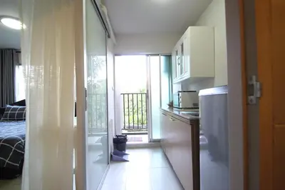 a kitchen with a refrigerator and a window in a room at Dcondo Kathu Patong Phuket by Suna in Kathu