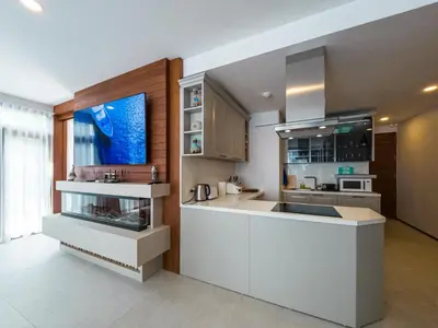 a kitchen with white cabinets and a counter top at Q Kata Residence in Kata Beach