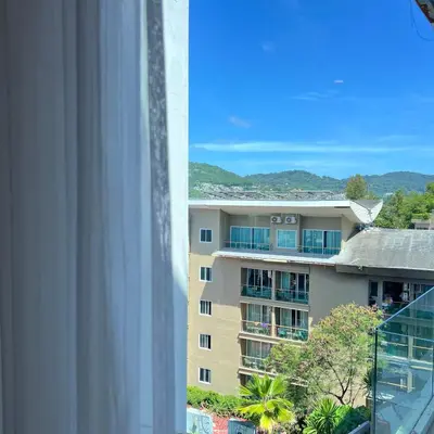 a view of a building from a window at Q Kata Residence in Kata Beach