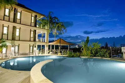 a swimming pool in front of a building at Kamala Villa Hill in Kamala Beach