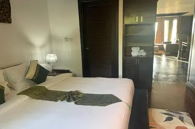 a bedroom with two beds and a living room at Kamala Villa Hill in Kamala Beach