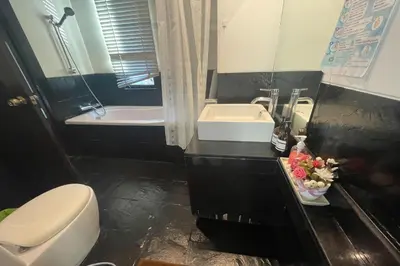 a bathroom with a toilet and a sink and a tub at Kamala Villa Hill in Kamala Beach