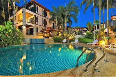 a swimming pool in front of a building at Kamala Villa Hill in Kamala Beach