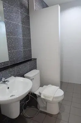 a bathroom with a white toilet and a sink at DOS'S HOUSE in Nai Yang Beach