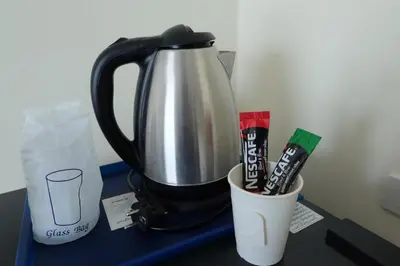 a mixer on a table with a cup and toothbrushes at DOS'S HOUSE in Nai Yang Beach