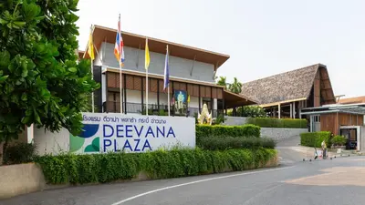 a sign in front of a building with flags at Deevana Plaza Krabi Aonang in Ao Nang Beach
