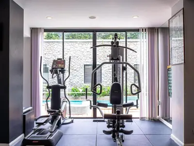 a gym with two treadmills and two exercise bikes at Deevana Plaza Krabi Aonang in Ao Nang Beach