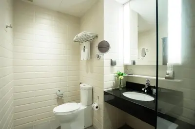 a bathroom with a toilet and a sink at Deevana Plaza Krabi Aonang in Ao Nang Beach