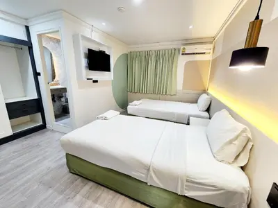 a hotel room with a bed and a tv at SEATEL Phuket, Patong Beach in Patong Beach