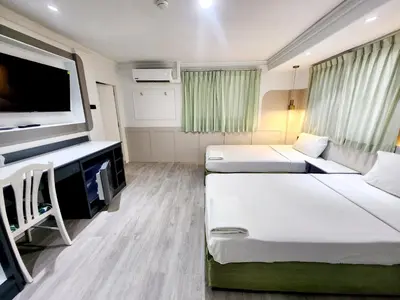 a hospital room with two beds and a flat screen tv at SEATEL Phuket, Patong Beach in Patong Beach
