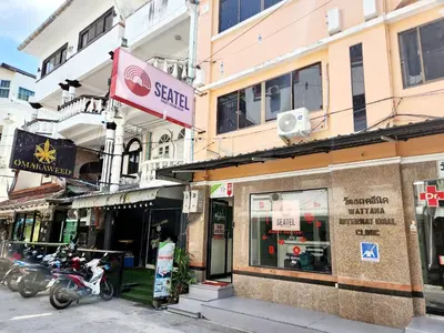 a group of motorcycles parked in front of buildings at SEATEL Phuket, Patong Beach in Patong Beach