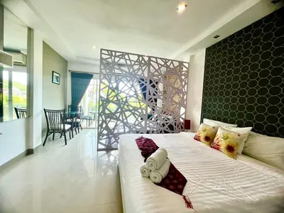 a bedroom with a large bed in a room at Sivana Place Phuket in Bang Tao Beach