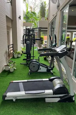 a gym with two tread machines on the grass at Sivana Place Phuket in Bang Tao Beach