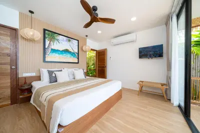 a bedroom with a bed and a ceiling fan at Friendship Beach Resort & Atmanjai Wellness Centre in Rawai Beach