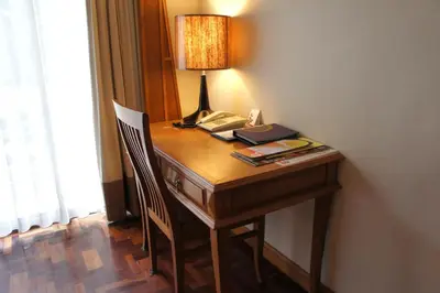 a desk with a lamp and a telephone on it at Safari Beach Hotel Patong in Patong Beach