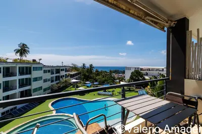 a balcony with a view of the ocean at KB Apartments Karon Beach by PHR in Karon Beach