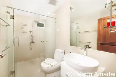 a bathroom with a shower and a toilet and a sink at KB Apartments Karon Beach by PHR in Karon Beach